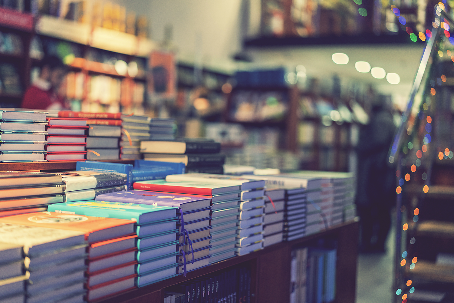 Books stacked on table representing The Page Bloom Publsihing  Publishing's comprehensive service